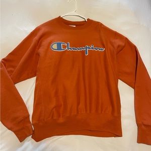 Burnt orange Champion hoodie with with baby blue and yellow writing! Size M!
